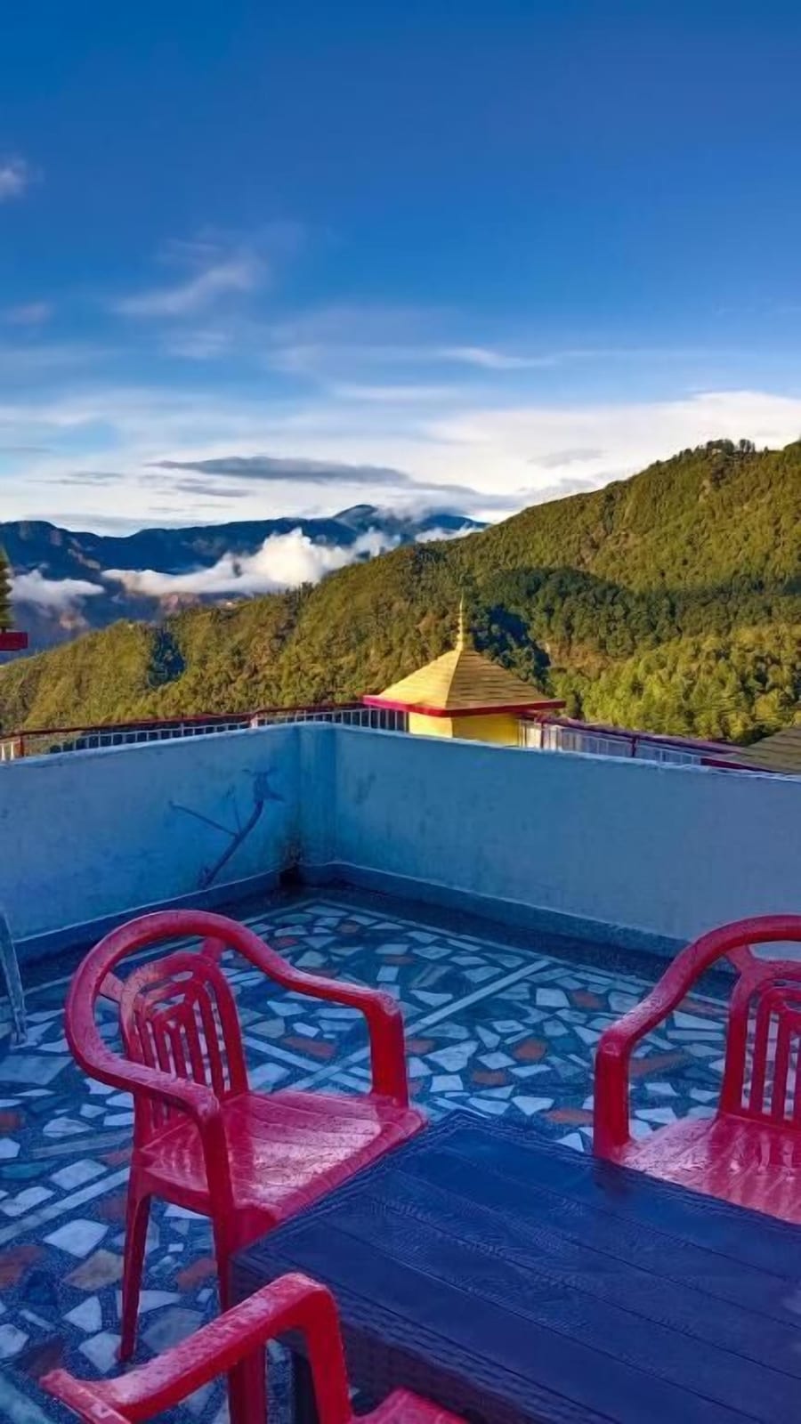 Rooftop seating at sunrise — Hotel Tourist Home by Palak Hospitality, Mussoorie