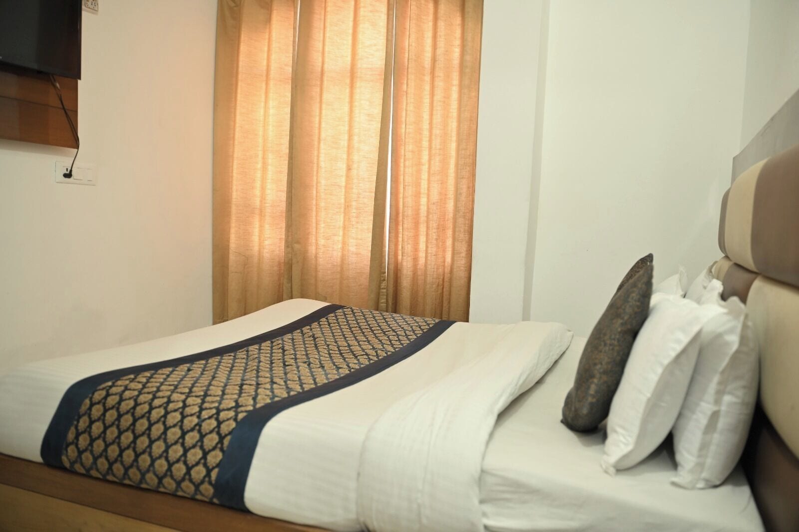 Deluxe room, bed and window — Hotel Tourist Home by Palak Hospitality, Mussoorie