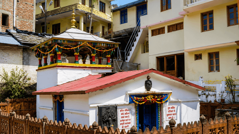 The small temple at Gaurikund among the buildings of the trailhead town